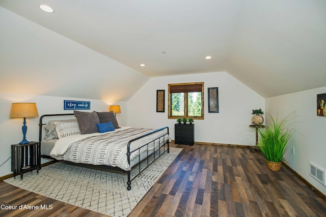 bedroom with baseboards, visible vents, wood finished floors, and vaulted ceiling