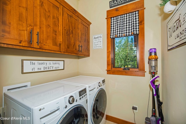 laundry room with baseboards, cabinet space, and independent washer and dryer