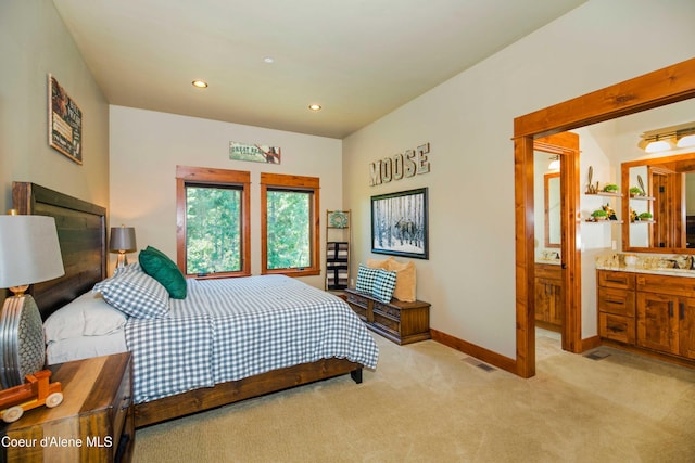 bedroom featuring light colored carpet, recessed lighting, baseboards, a sink, and connected bathroom