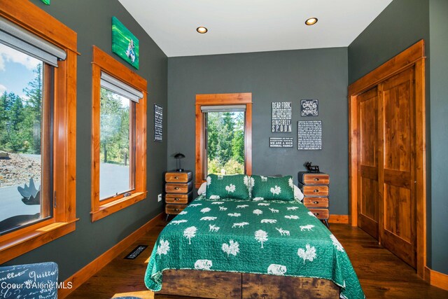 bedroom with baseboards, recessed lighting, and dark wood-type flooring