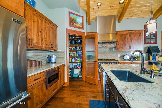 kitchen with stainless steel appliances, a sink, extractor fan, dark wood-style floors, and wooden ceiling