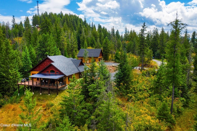 drone / aerial view featuring a wooded view