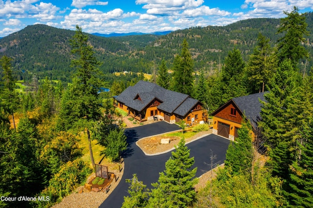 drone / aerial view with a forest view and a mountain view