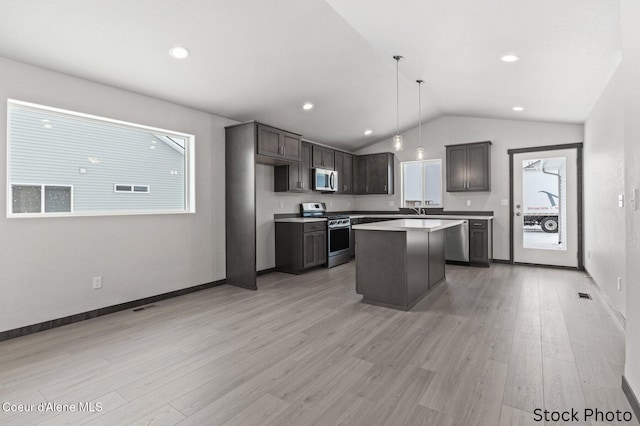11669 N Railway Ave, Rathdrum, ID 83858 - kitchen with stainless steel appliances, lofted ceiling, light wood-style flooring, light countertops, and a center island