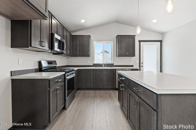 11669 N Railway Ave, Rathdrum, ID 83858 - kitchen with stainless steel appliances, lofted ceiling, light wood-style flooring, light countertops, and pendant lighting