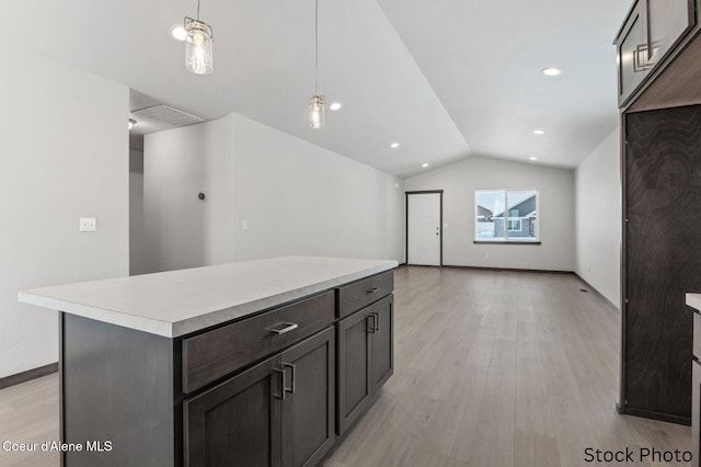 11669 N Railway Ave, Rathdrum, ID 83858 - kitchen featuring vaulted ceiling, light wood-style floors, light countertops, decorative light fixtures, and a kitchen island