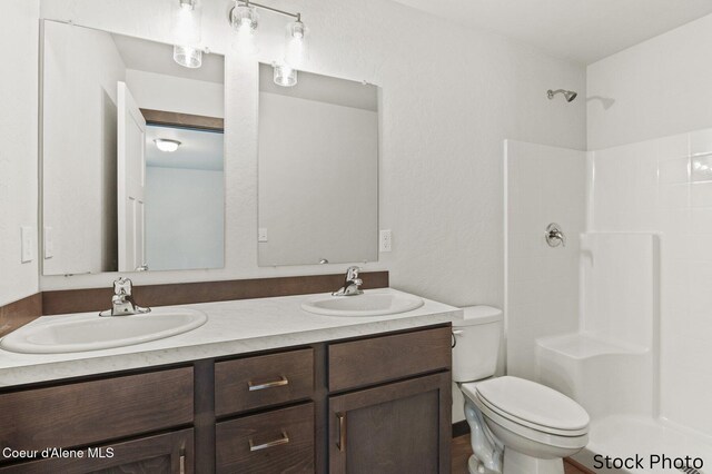 11669 N Railway Ave, Rathdrum, ID 83858 - full bathroom with toilet, a shower, and double vanity