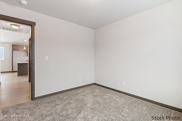 11669 N Railway Ave, Rathdrum, ID 83858 - unfurnished room with attic access, light carpet, baseboards, and a smoke detector