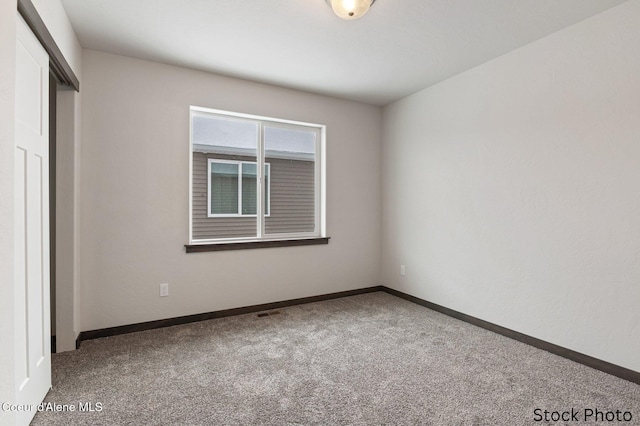 11669 N Railway Ave, Rathdrum, ID 83858 - unfurnished bedroom featuring carpet floors, baseboards, and a closet