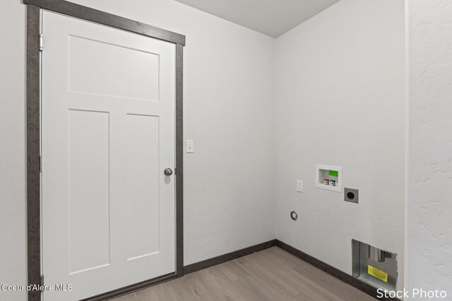 11669 N Railway Ave, Rathdrum, ID 83858 - clothes washing area with light wood-style flooring, hookup for a washing machine, hookup for an electric dryer, and baseboards