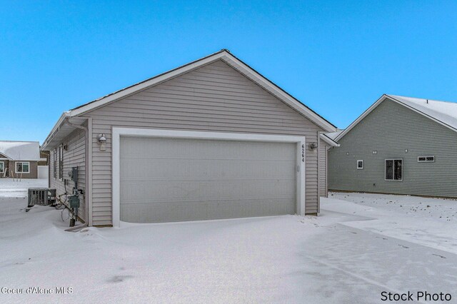 11669 N Railway Ave, Rathdrum, ID 83858 - snow covered garage featuring cooling unit and a detached garage