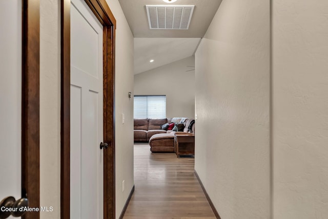 12379 N Cavanaugh Dr, Rathdrum, ID 83858 - hallway with lofted ceiling, wood finished floors, and baseboards