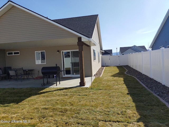 12379 N Cavanaugh Dr, Rathdrum, ID 83858 - rear view of house featuring a patio, a gate, and roof with shingles