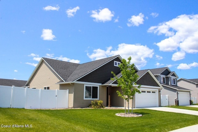 12379 N Cavanaugh Dr, Rathdrum, ID 83858 - view of front of property with driveway, an attached garage, and a shingled roof
