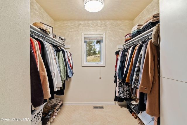 spacious closet with carpet flooring and visible vents