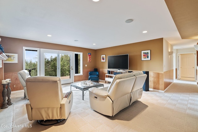 living room with wainscoting, wooden walls, and recessed lighting