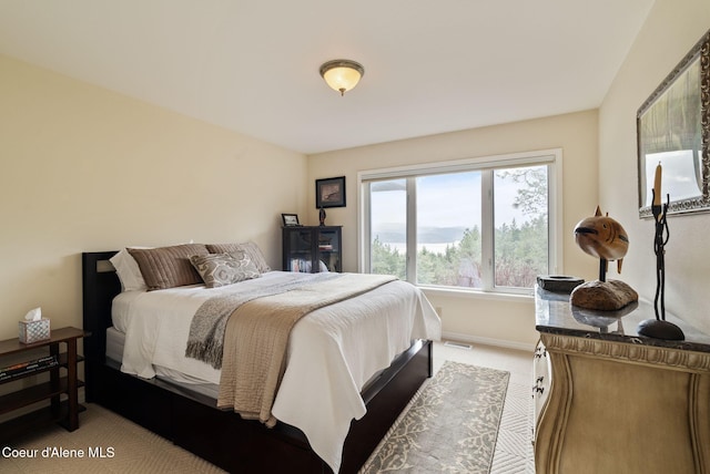 bedroom with carpet floors, baseboards, and visible vents