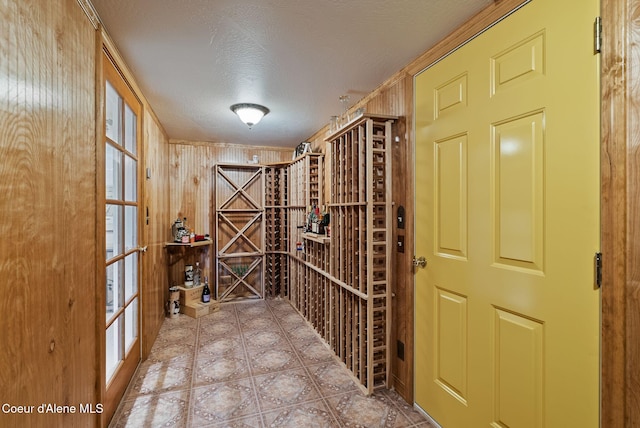 wine cellar with tile patterned flooring and a textured ceiling
