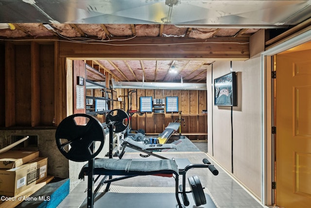 workout area featuring wood walls