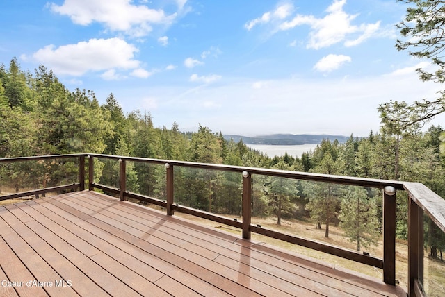 wooden terrace with a view of trees
