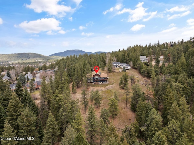 aerial view with a wooded view and a mountain view