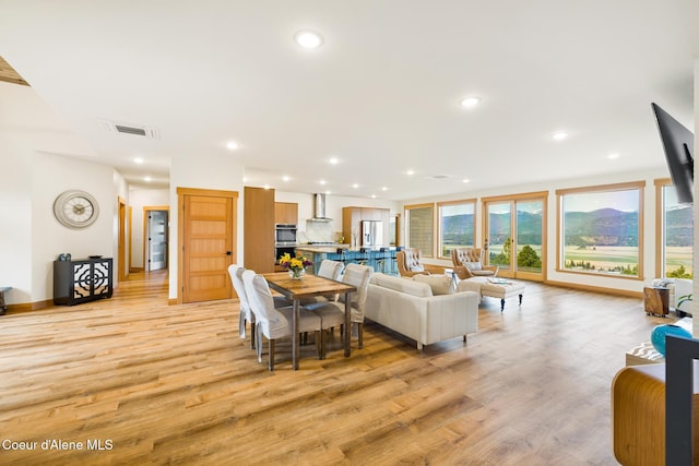 living room with recessed lighting, baseboards, visible vents, and light wood-type flooring