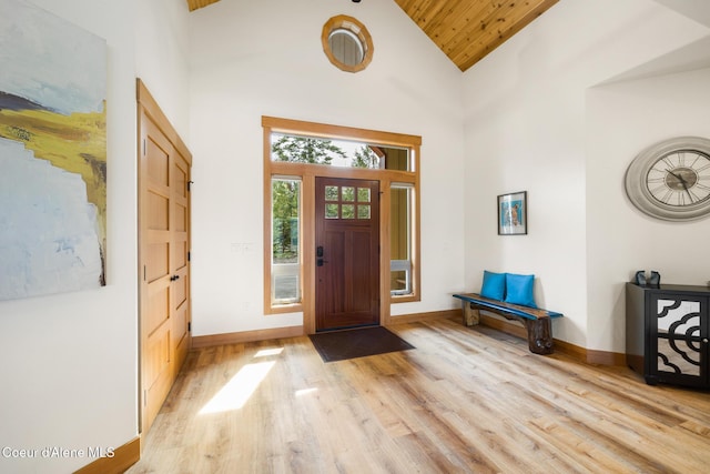 entrance foyer featuring baseboards, wooden ceiling, high vaulted ceiling, and light wood-type flooring