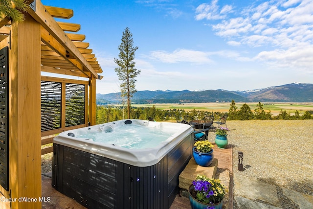 view of yard featuring a mountain view and a hot tub