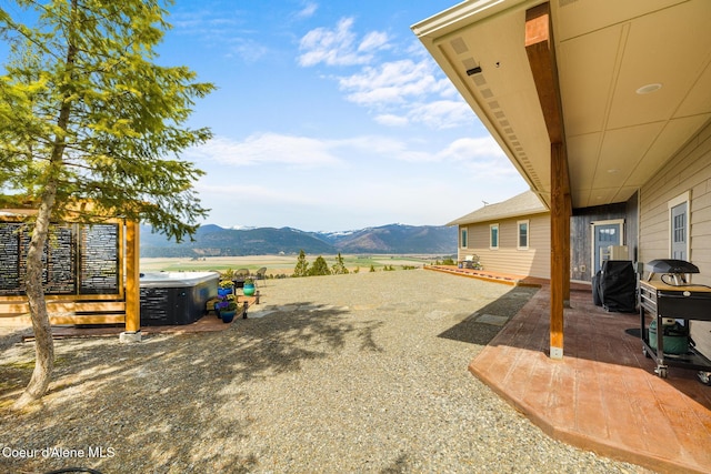 view of yard featuring a mountain view and a patio