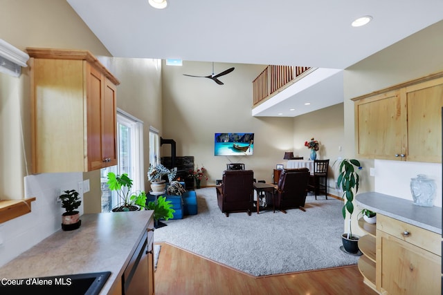 home office with wood finished floors, a towering ceiling, recessed lighting, and a ceiling fan