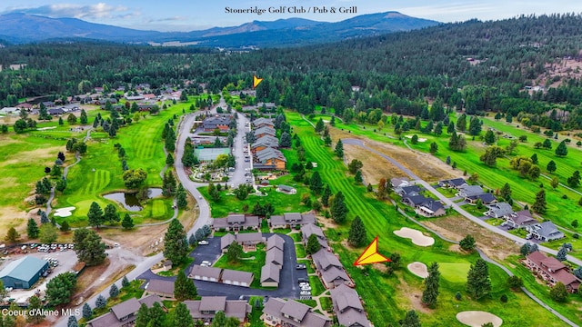birds eye view of property with a wooded view, a residential view, view of golf course, and a mountain view