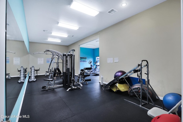 exercise room featuring baseboards and visible vents