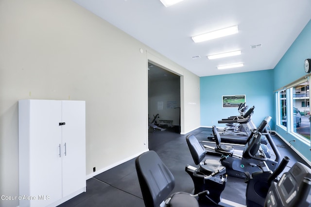 gym featuring baseboards and visible vents