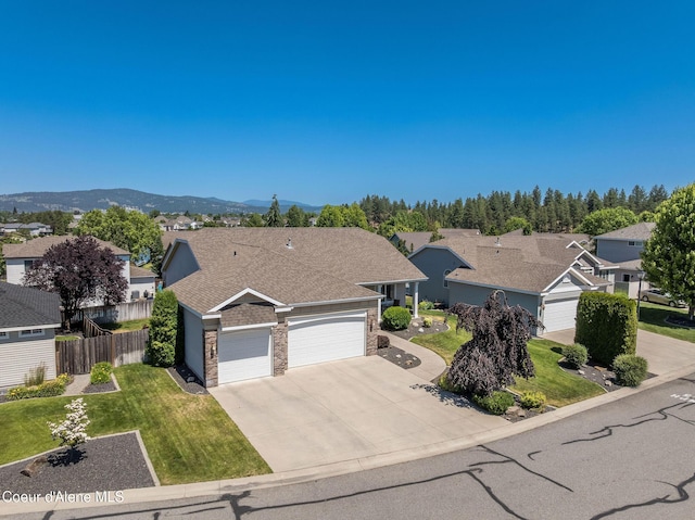 16221 E 9th Ln, Spokane Valley, WA 99037 - view of front of home with an attached garage, driveway, a residential view, and stone siding