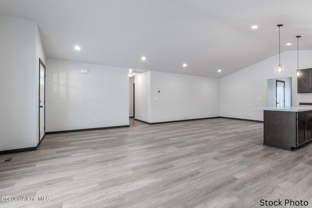 unfurnished living room with baseboards, lofted ceiling, recessed lighting, and light wood-type flooring