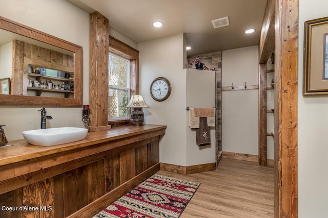 488 Fawn Ln, Bonners Ferry, ID 83805 - bathroom featuring wood finished floors, vanity, baseboards, visible vents, and recessed lighting