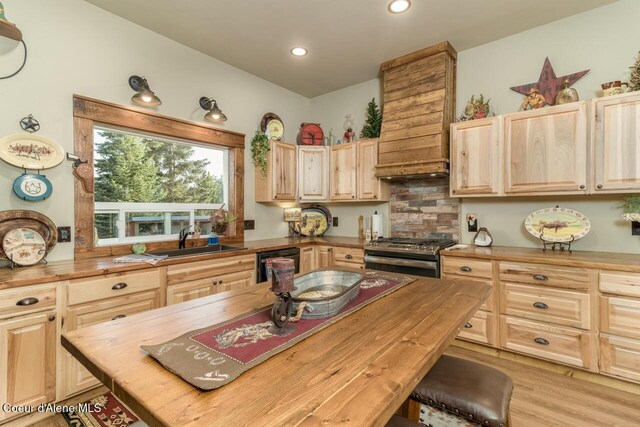 488 Fawn Ln, Bonners Ferry, ID 83805 - kitchen with light brown cabinetry, wooden counters, stainless steel gas stove, dishwashing machine, and a sink