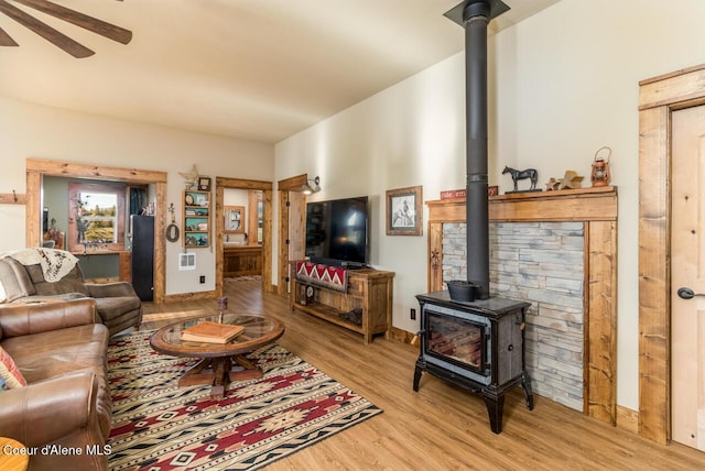 488 Fawn Ln, Bonners Ferry, ID 83805 - living area featuring ceiling fan, baseboards, light wood-style floors, and a wood stove