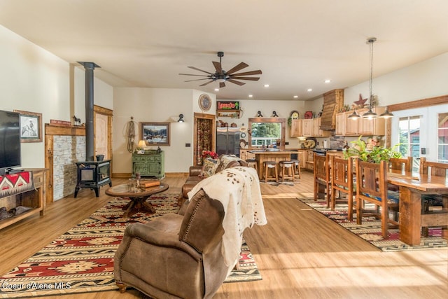 488 Fawn Ln, Bonners Ferry, ID 83805 - living room featuring light wood-type flooring, ceiling fan, recessed lighting, and a wood stove
