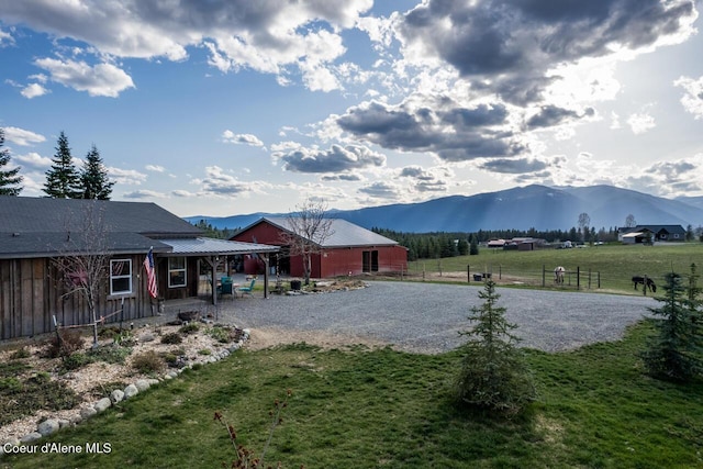 488 Fawn Ln, Bonners Ferry, ID 83805 - view of yard with driveway, fence, and a mountain view