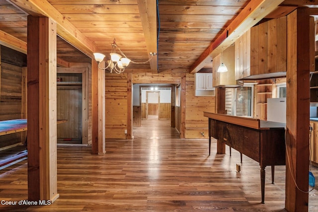 corridor with wood walls, an inviting chandelier, wooden ceiling, beamed ceiling, and wood finished floors