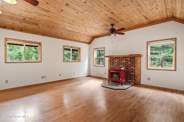 unfurnished living room with ceiling fan, vaulted ceiling, and plenty of natural light