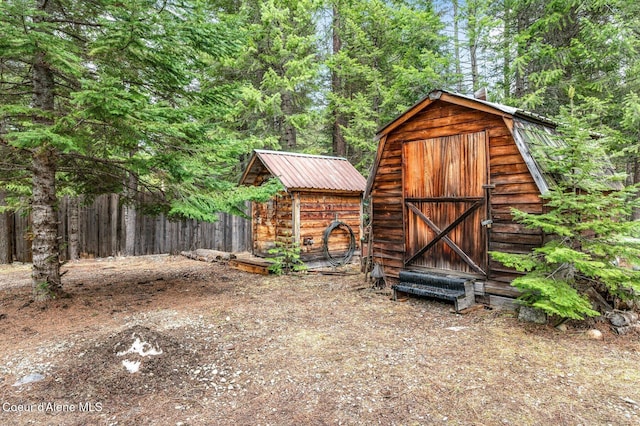 view of shed featuring fence