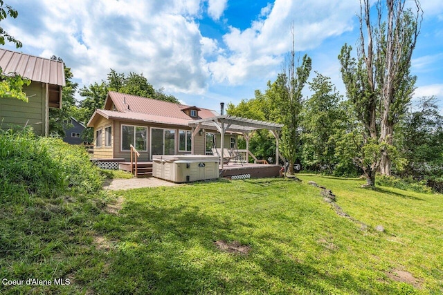 118 E Lincoln Ave, Harrison, ID 83833 - rear view of house with a hot tub, metal roof, a deck, a pergola, and a lawn