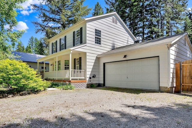 12854 E Hellroaring Rd, Athol, ID 83801 - view of front of property featuring a porch, a garage, and driveway