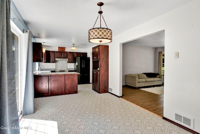 12854 E Hellroaring Rd, Athol, ID 83801 - kitchen with open floor plan, freestanding refrigerator, a peninsula, and healthy amount of natural light
