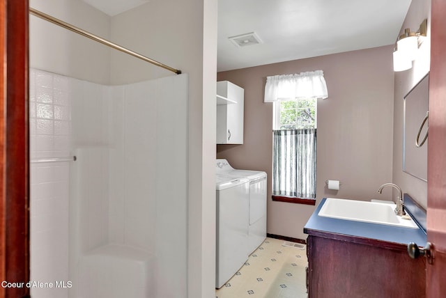12854 E Hellroaring Rd, Athol, ID 83801 - laundry area featuring washing machine and dryer, baseboards, and cabinet space