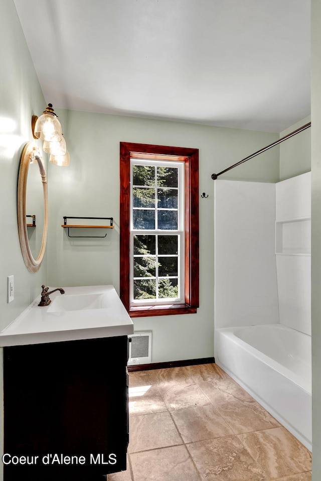 12854 E Hellroaring Rd, Athol, ID 83801 - full bathroom with vanity, washtub / shower combination, and baseboards