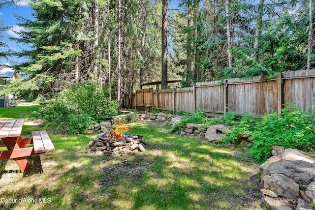 12854 E Hellroaring Rd, Athol, ID 83801 - fenced backyard with a fire pit
