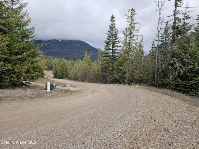 view of road featuring a mountain view and a view of trees